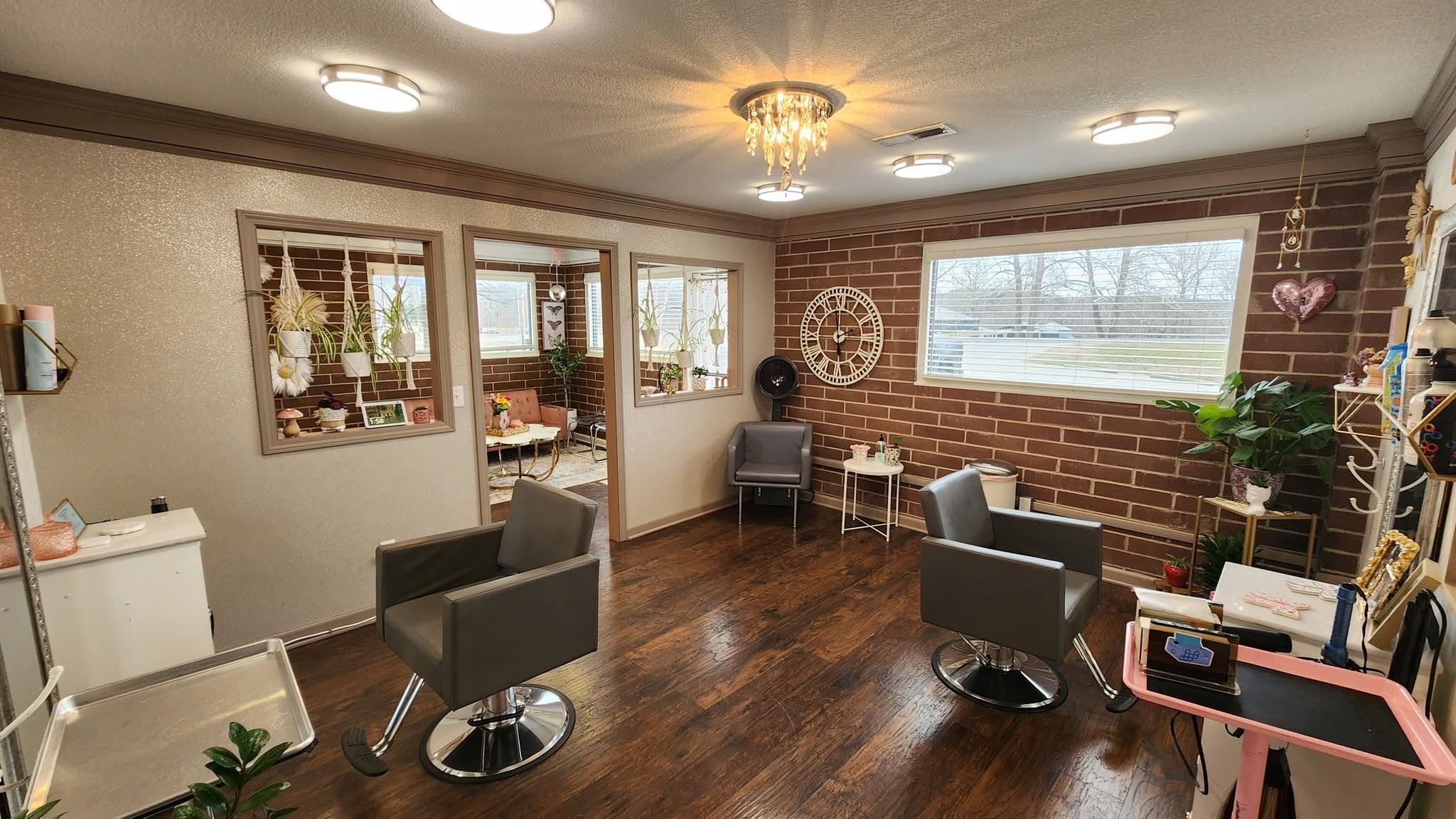 Styling stations and exposed brick inside Pretty Parlor Hair